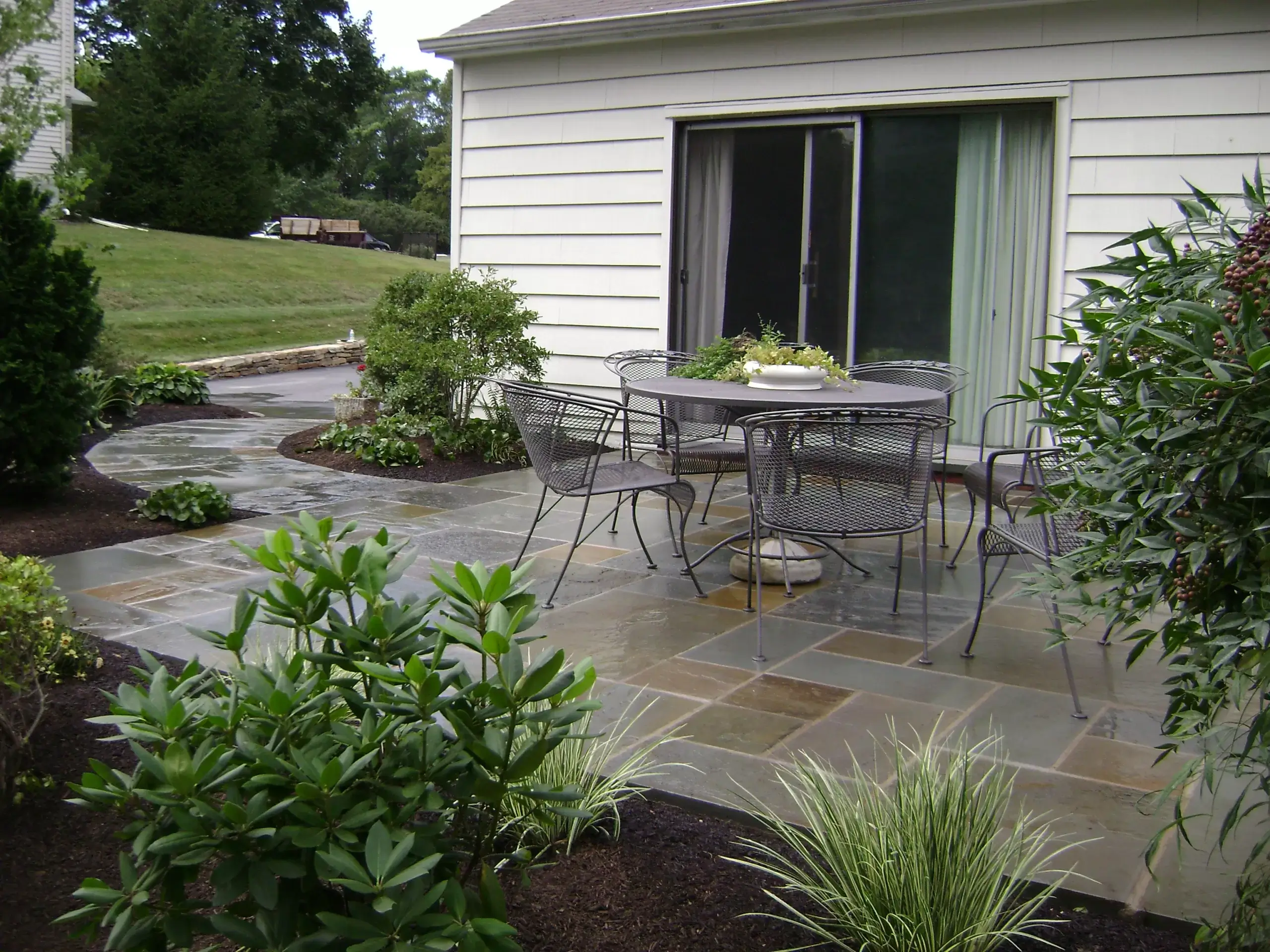Flag Stone Patio with Mulched Beds and Plants